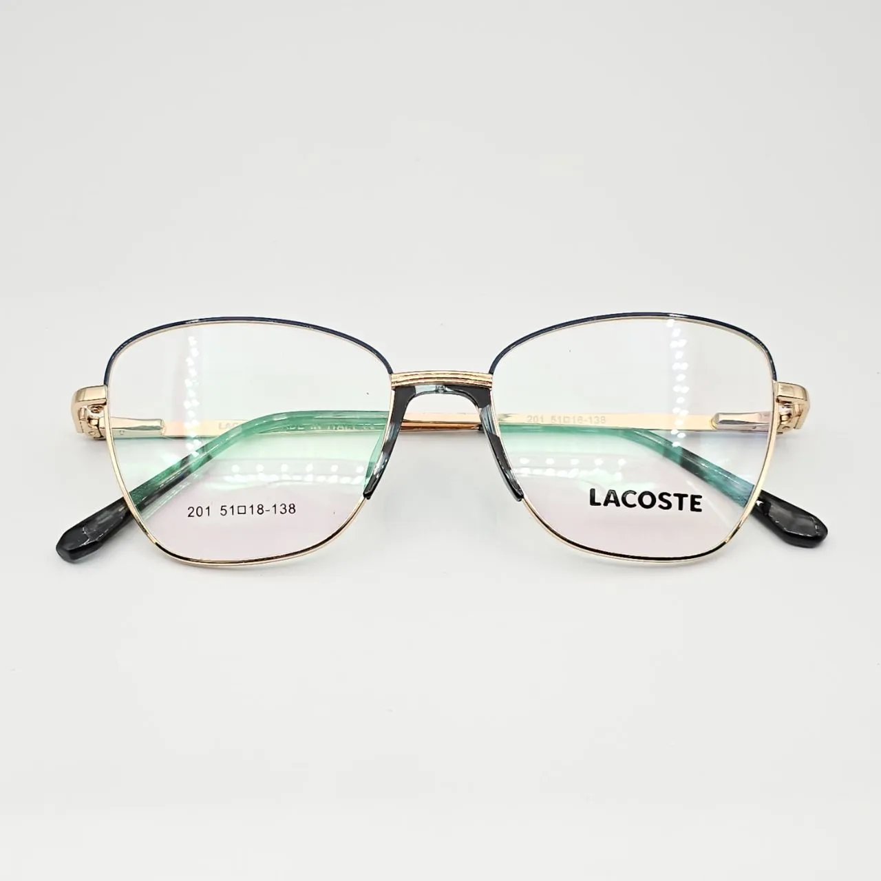 عکس نمای از بالا عینک طبی زنانه فلزی گربه ای برند Lacoste کد 201 رنگ gold,blue