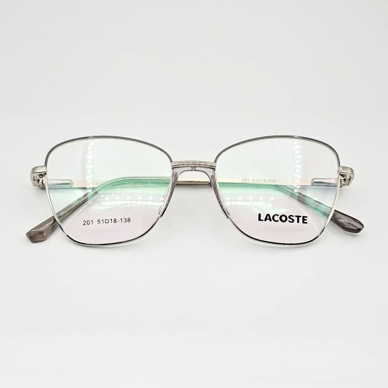 عکس نمای از بالا عینک طبی زنانه فلزی گربه ای برند Lacoste کد 201 رنگ silver,transparent