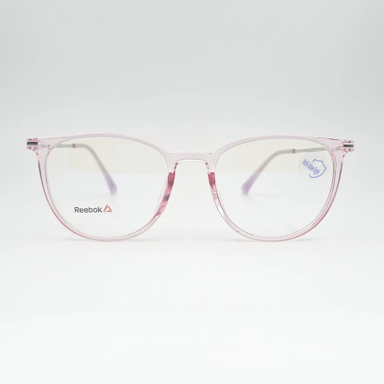 خرید عینک طبی گرد بلوکات و شفاف برند Reebok رنگ pink