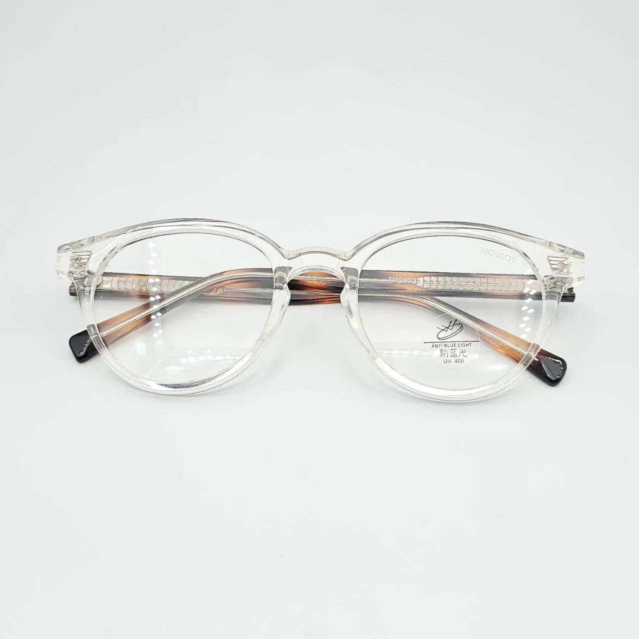 عکس نمای دسته عینک طبی گرد شفاف TR90 با دسته پلنگی برند MOSCOT رنگ transparent,leopard